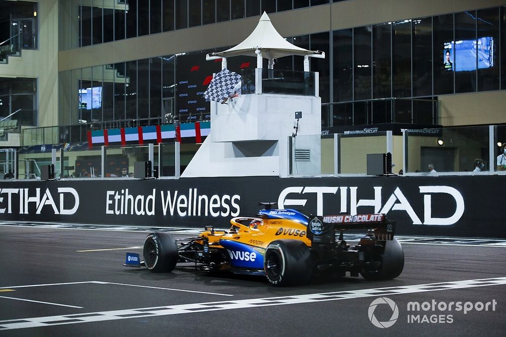 Carlos Sainz Jr., McLaren MCL35, crosses the line to take te checkered flag