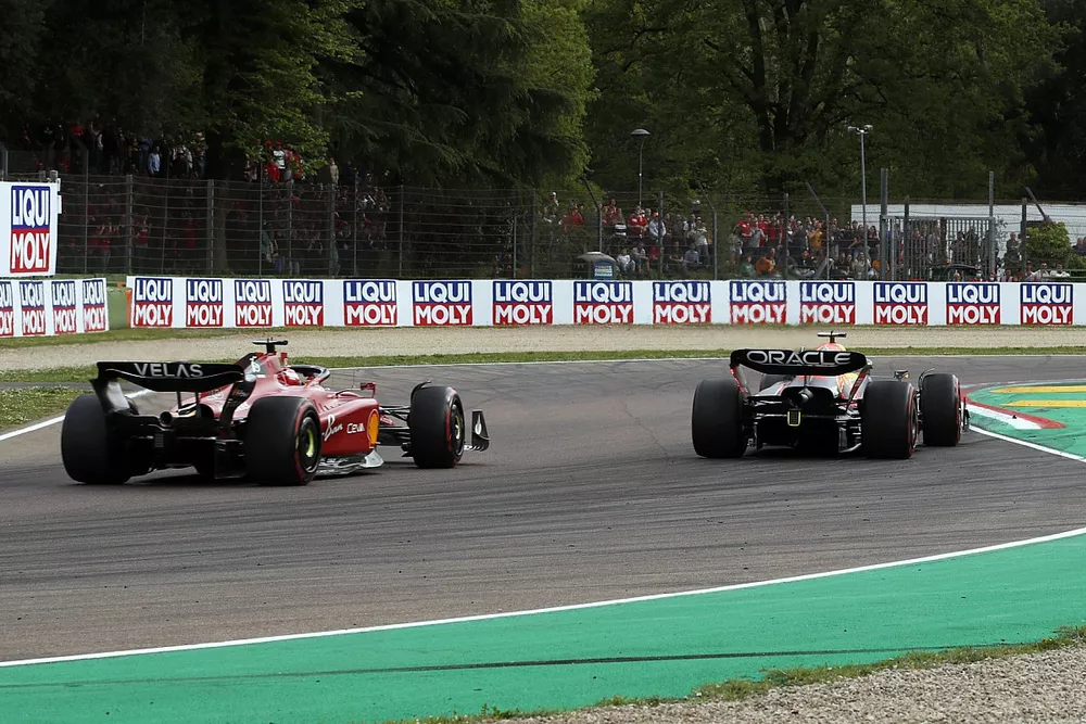 Max Verstappen, Red Bull Racing RB18, passes Charles Leclerc, Ferrari F1-75, for the lead