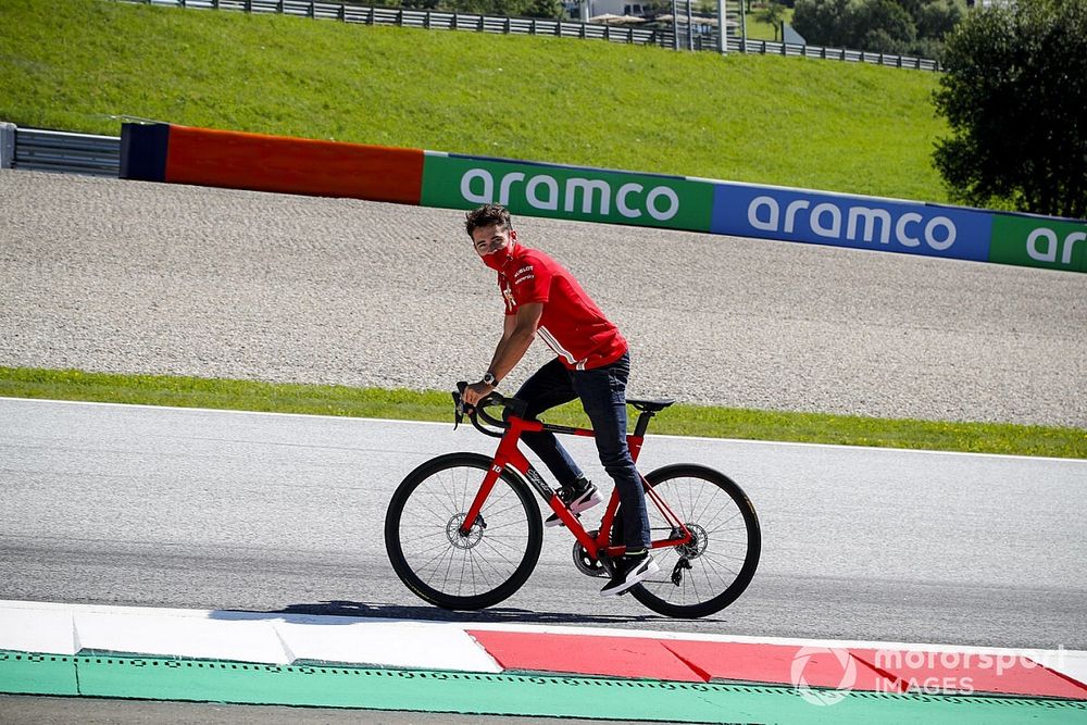 Charles Leclerc, Ferrari walks the track on a bike