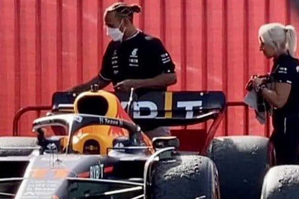 Lewis Hamilton, Mercedes, walks behind Sergio Perez's Red Bull at the Spanish GP.
