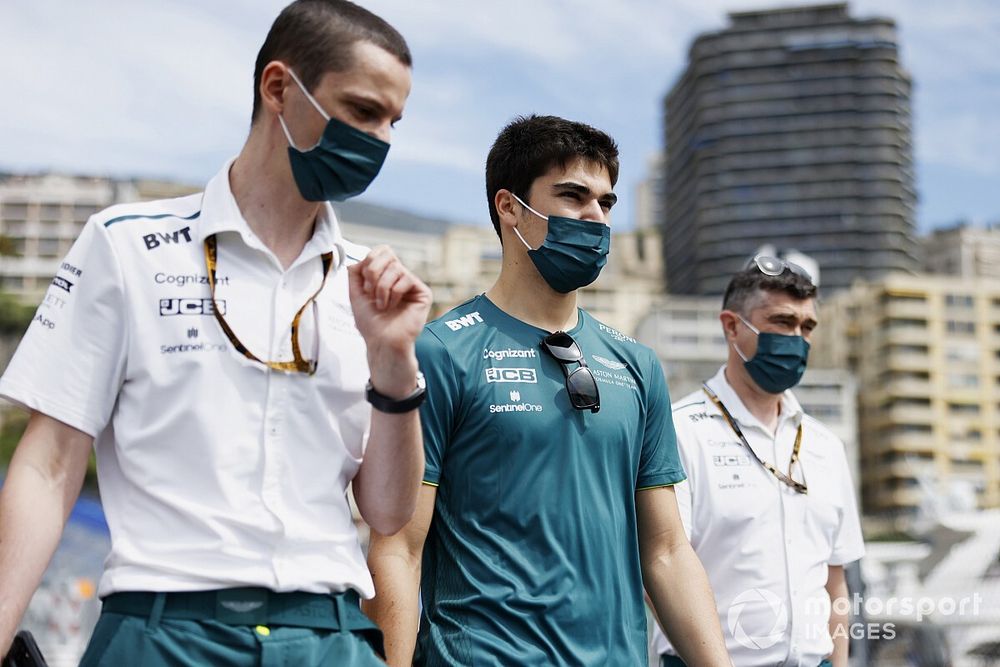 Lance Stroll, Aston Martin, walks the track with team mates