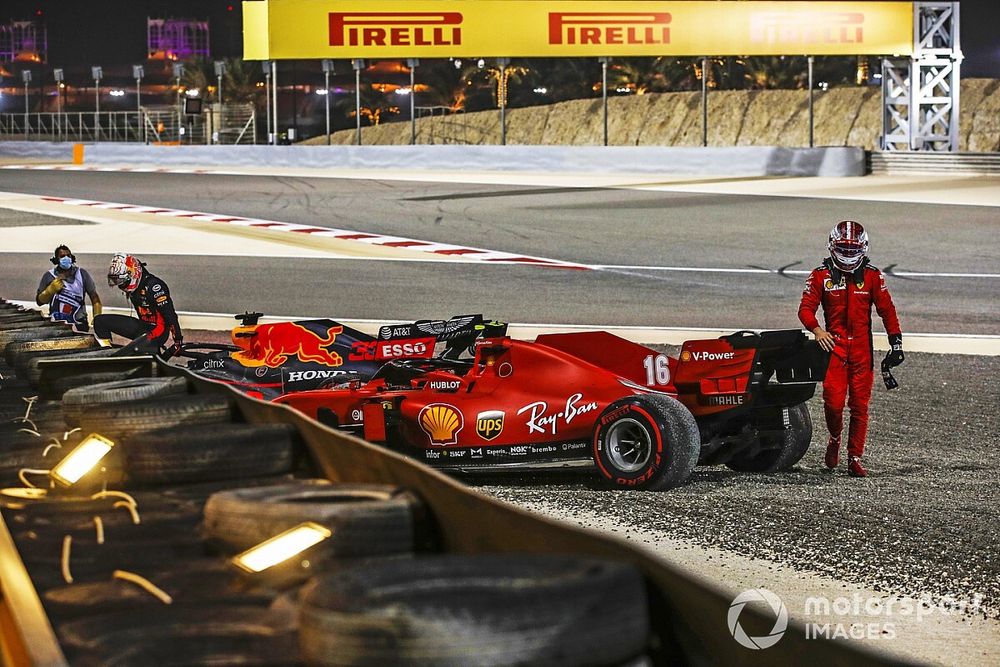 Max Verstappen, Red Bull Racing, and Charles Leclerc, Ferrari, walk away from their cars after retiring