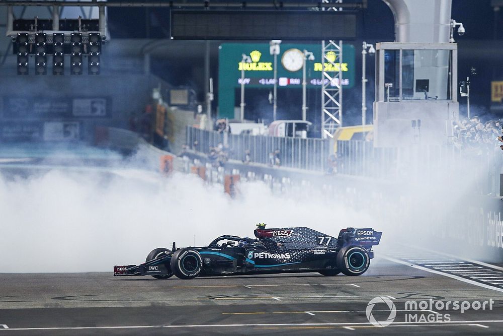 Lewis Hamilton, Mercedes F1 W11, 3rd position, and Valtteri Bottas, Mercedes F1 W11, 2nd position, perform celebratory donuts on the grid after the race