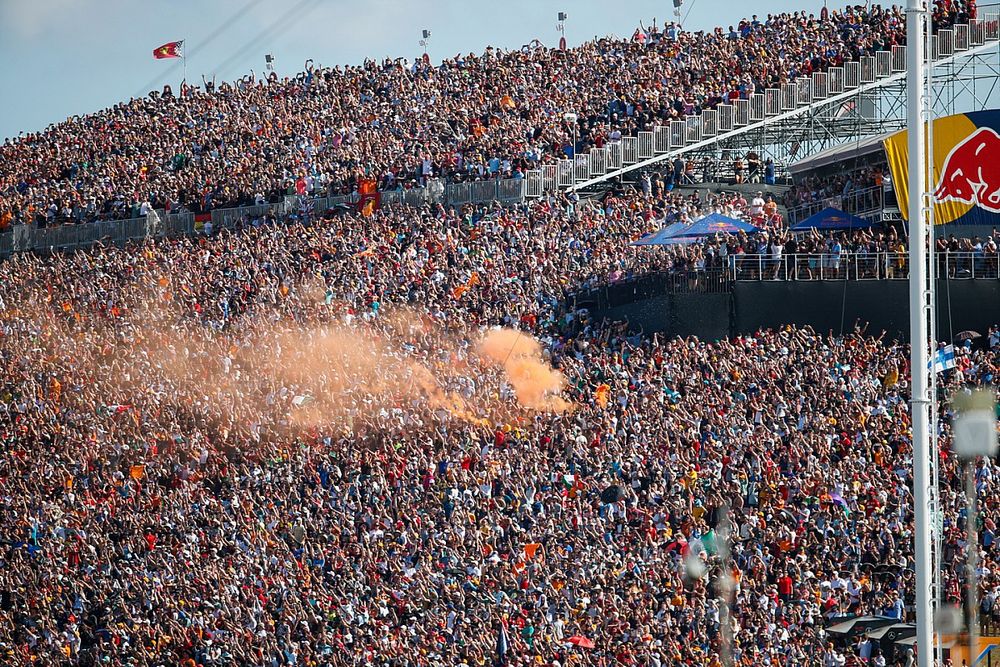 A smoke flare is set off in a grandstand