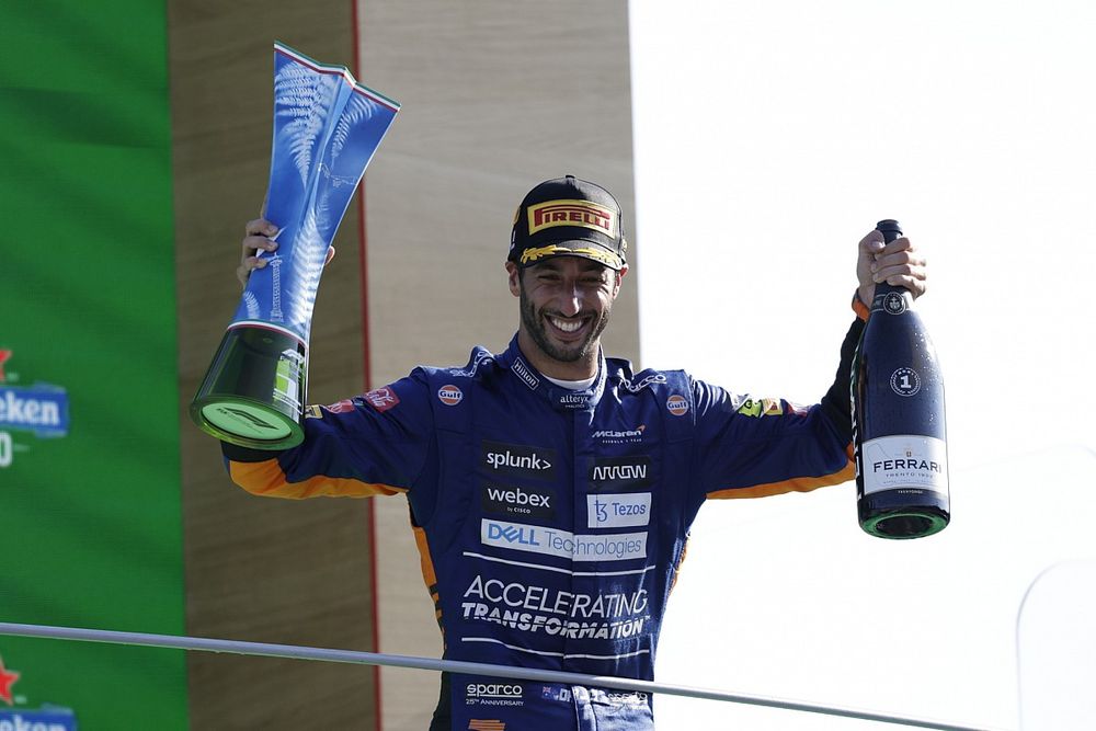 Daniel Ricciardo, McLaren, 1st position, with his trophy and Champagne on the podium