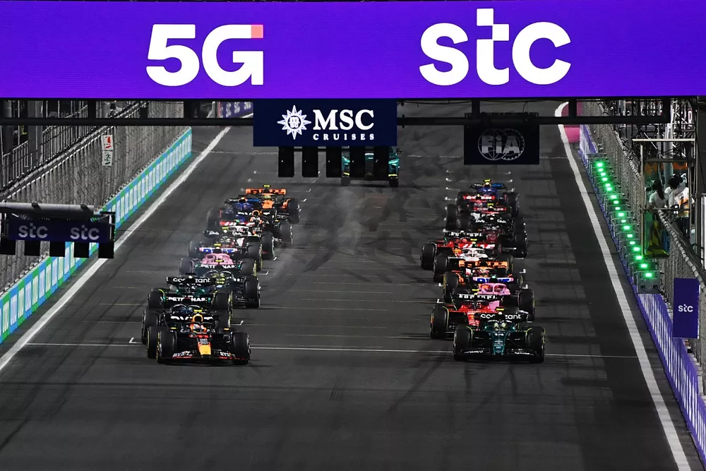 Sergio Perez, Red Bull Racing RB19, Fernando Alonso, Aston Martin AMR23, lead the field away at the start