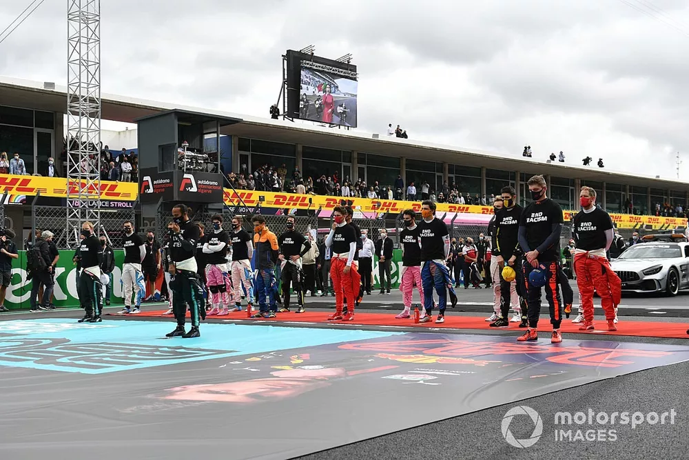 The drivers stand for the national anthem prior to the start in their End Racism teeshirts