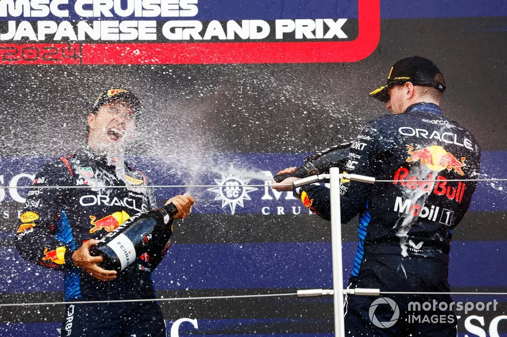 Sergio Perez, Red Bull Racing, 2nd position, Max Verstappen, Red Bull Racing, 1st position, celebrate with Champagne on the podium
