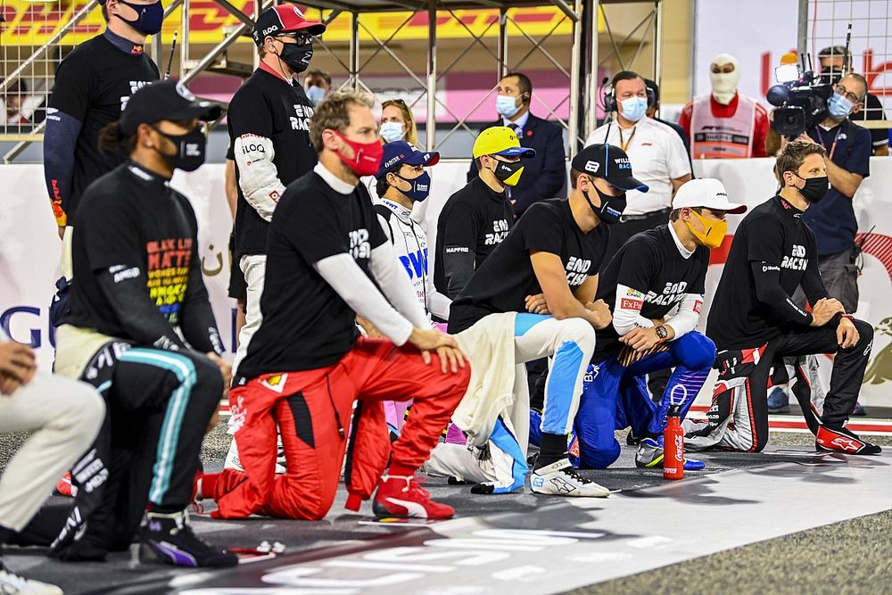 The drivers stand and kneel in support of the End Racsim campaign prior to the start