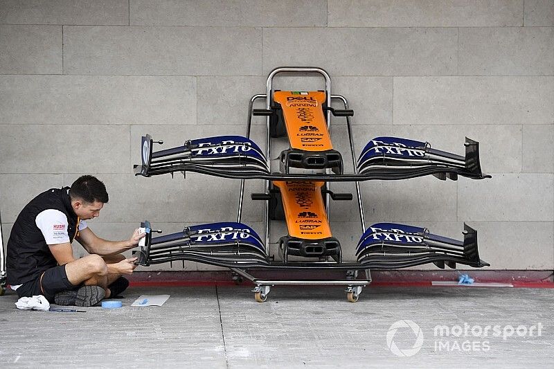 McLaren mechanic with McLaren MCL34 front wing