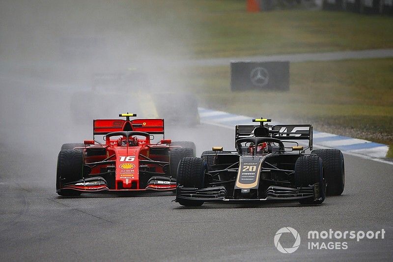 Kevin Magnussen, Haas F1 Team VF-19, leads Charles Leclerc, Ferrari SF90