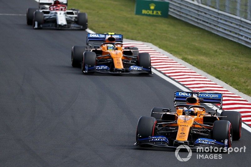 Carlos Sainz Jr., McLaren MCL34, leads Lando Norris, McLaren MCL34, and Kimi Raikkonen, Alfa Romeo Racing C38