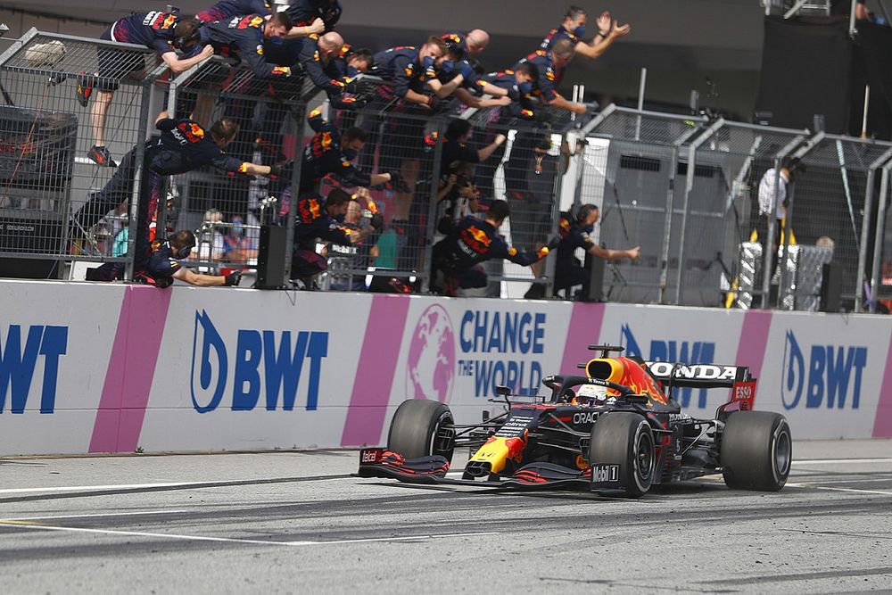 Race winner Max Verstappen, Red Bull Racing RB16B passes his team as they celebrate on the pit wall

