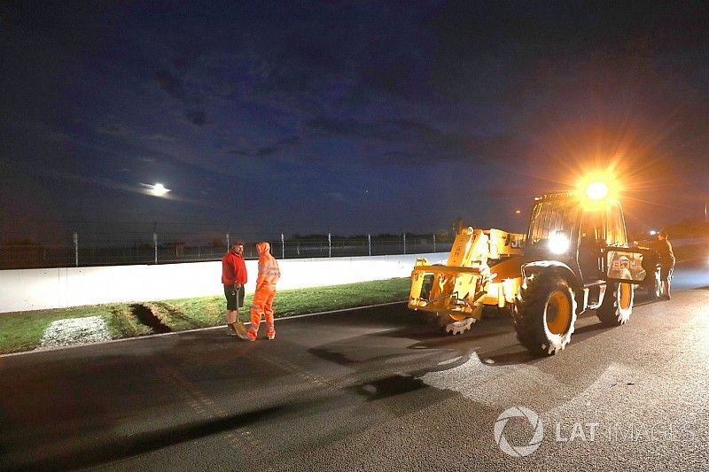 Crews work to improve drainage on the circuit before Sunday's race