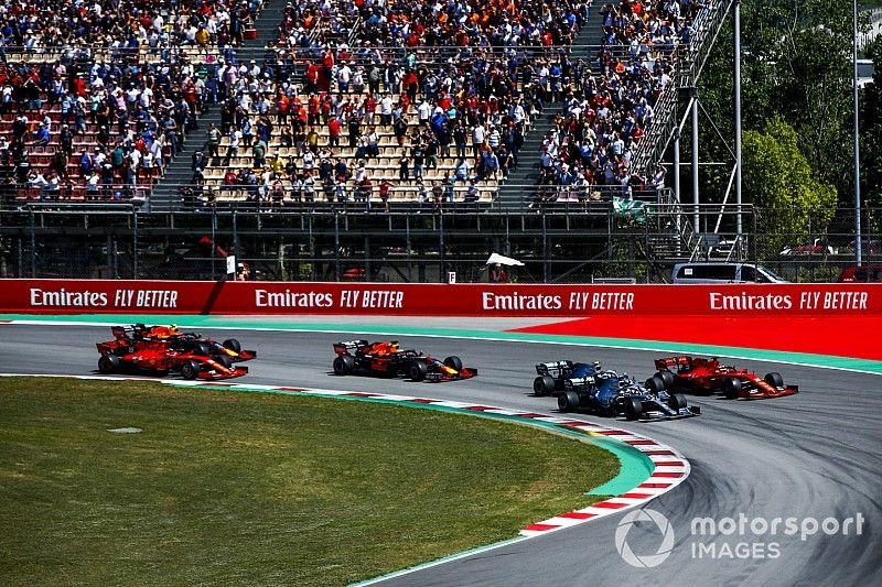 Lewis Hamilton, Mercedes AMG F1 W10, Valtteri Bottas, Mercedes AMG W10, and Sebastian Vettel, Ferrari SF90, race side by side ahead of Max Verstappen, Red Bull Racing RB15, Charles Leclerc, Ferrari SF90, and Pierre Gasly, Red Bull Racing RB15, in the first corner at the start