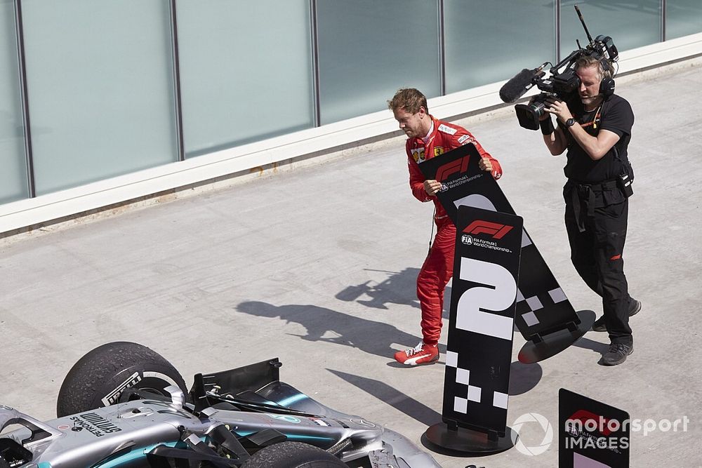 Sebastian Vettel, Ferrari, 2nd position, switches the position boards in protest of a penalty that cost him victory