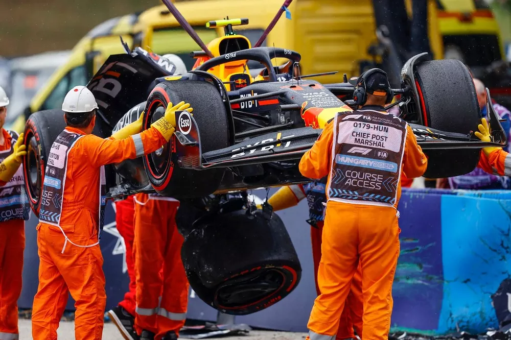Marshals remove the damaged car of Sergio Perez, Red Bull Racing RB20