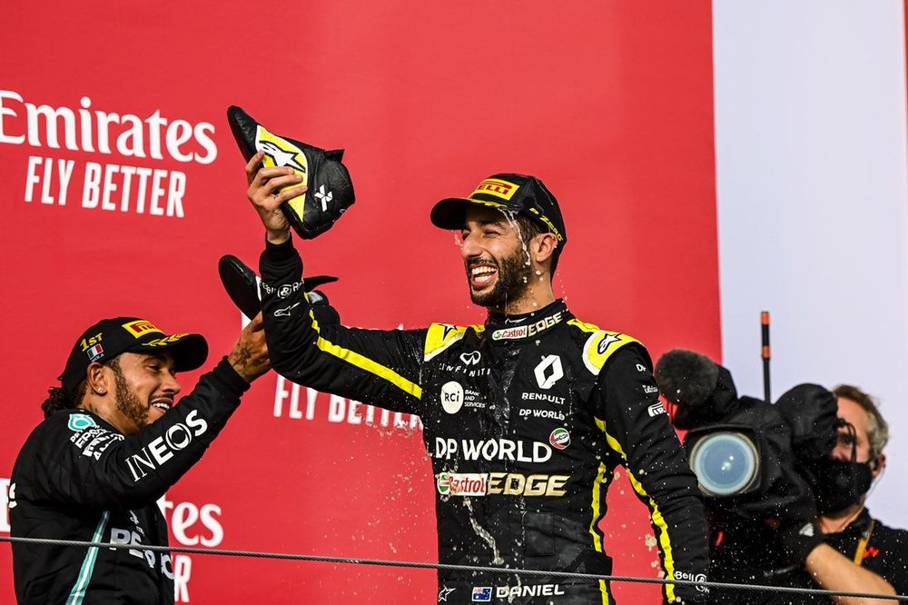 Lewis Hamilton, Mercedes-AMG F1, 1st position, and Daniel Ricciardo, Renault F1, 3rd position, drink from shoes on the podium