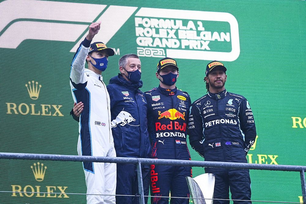 George Russell, Williams, 2nd position, the Red Bull trophy delegate, Max Verstappen, Red Bull Racing, 1st position, and Lewis Hamilton, Mercedes, 3rd position, on the podium