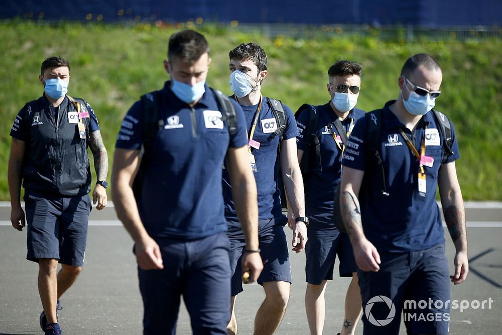 Members of the AlphaTauri team arrive at the track