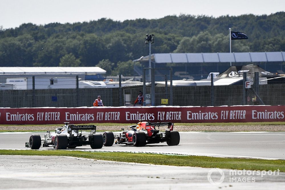 Romain Grosjean, Haas VF-20, and Max Verstappen, Red Bull Racing RB16, run side by side