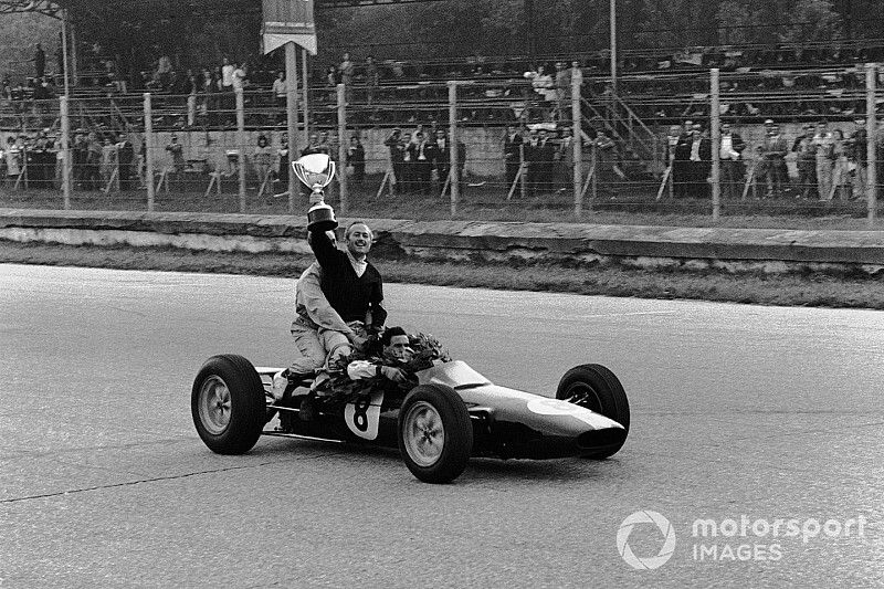 Jim Clark, Lotus 25 Climax le da un impulso al jefe del equipo, Colin Chapman, ya que celebran terminar en la 1ª posición y asegurar los títulos de Campeones del Mundo de pilotos y constructores