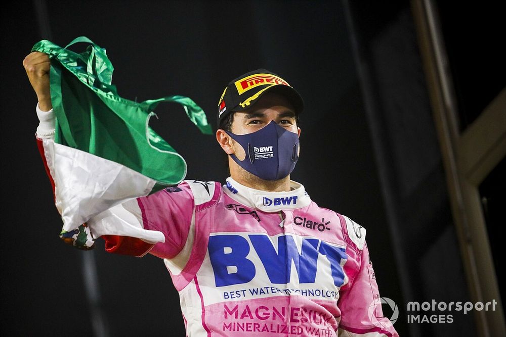 Sergio Perez, Racing Point, 1st position, celebrates with a Mexican flag on the podium