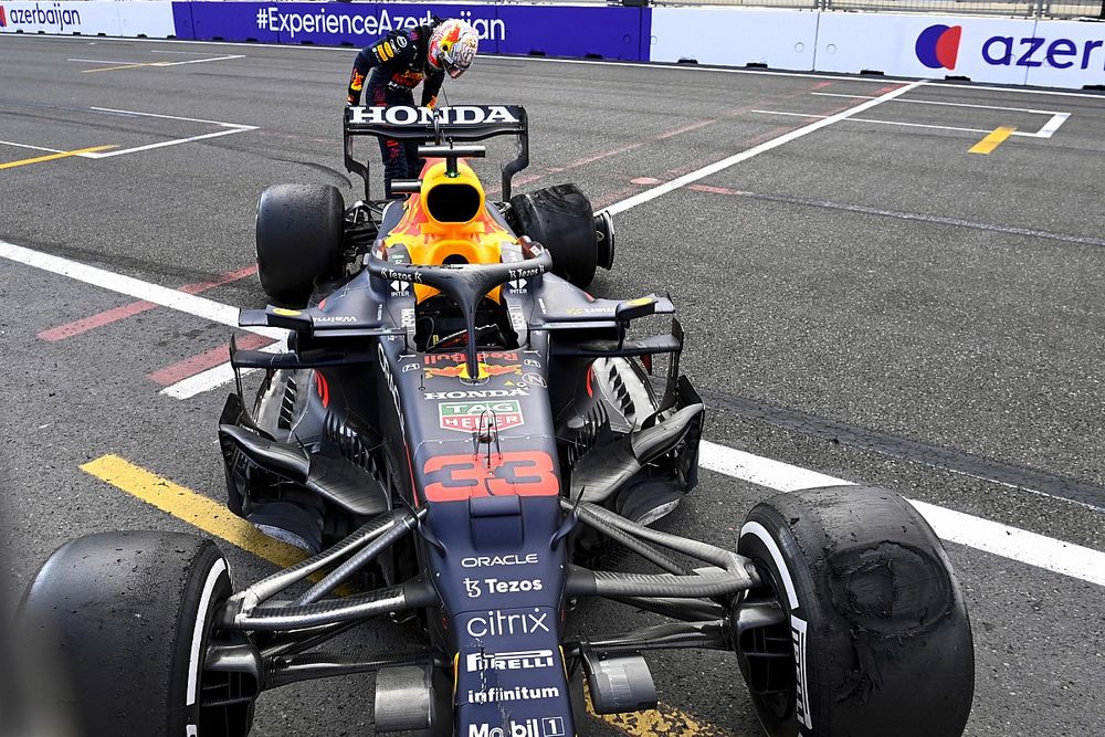 Max Verstappen, Red Bull Racing RB16B looking at the tyre after retiring from the race 