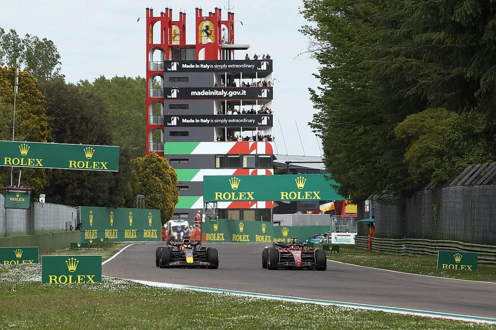 Max Verstappen, Red Bull Racing RB18, passes Charles Leclerc, Ferrari F1-75, for the lead