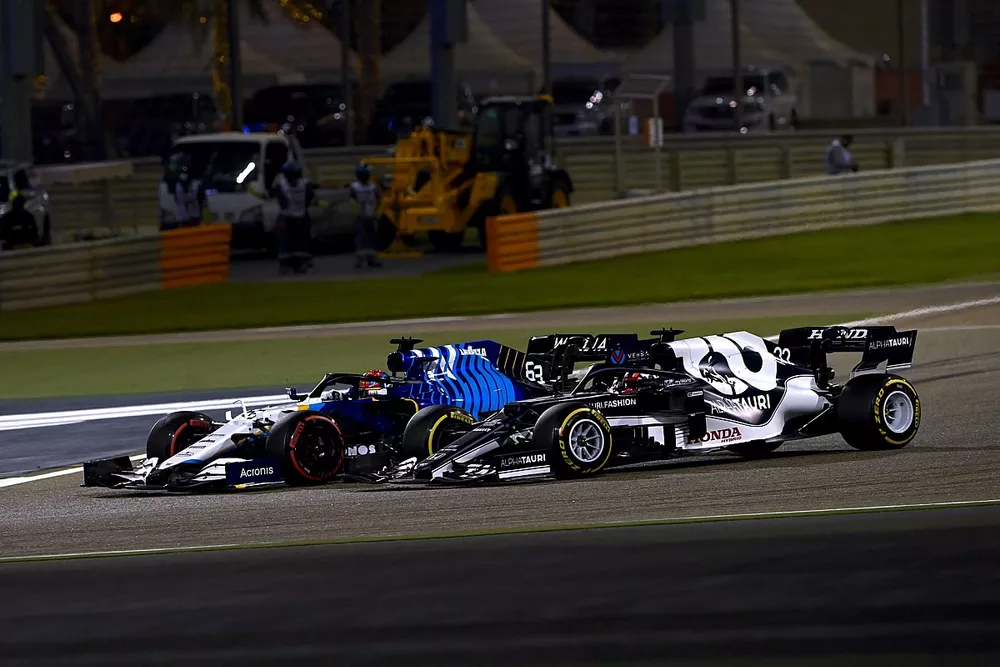 George Russell, Williams FW43B, and Yuki Tsunoda, AlphaTauri AT02, go off track whilst battling for position