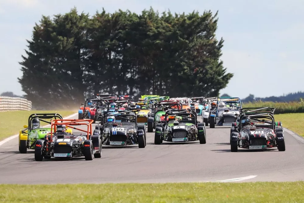 Craig Land (1) leads the way on the opening lap of the Locost race