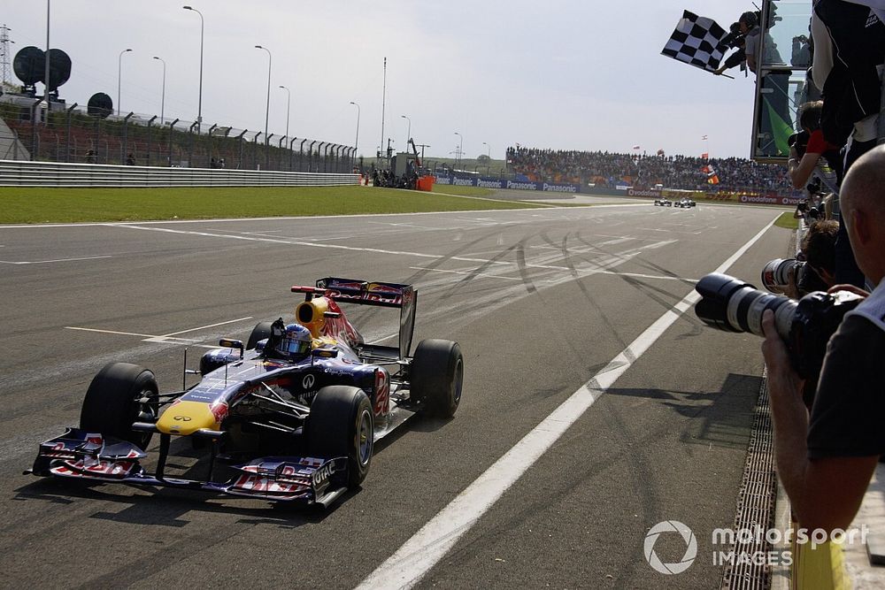 Sebastian Vettel, Red Bull RB7 Renault, crosses the finish line and takes the chequered flag