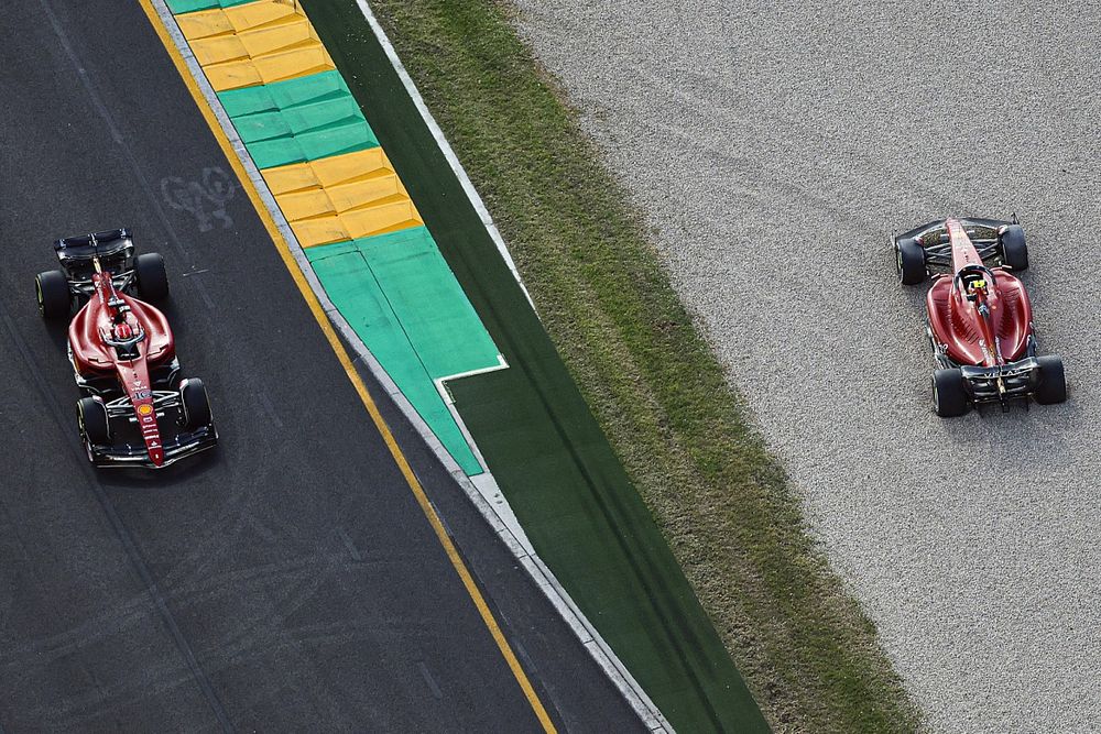 Charles Leclerc, Ferrari F1-75, passes the beached car of Carlos Sainz Jr., Ferrari F1-75