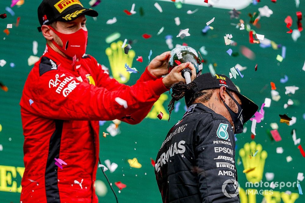 Sebastian Vettel, Ferrari, 3rd position, pours Champagne down the back of Lewis Hamilton, Mercedes-AMG F1, 1st position, on the podium