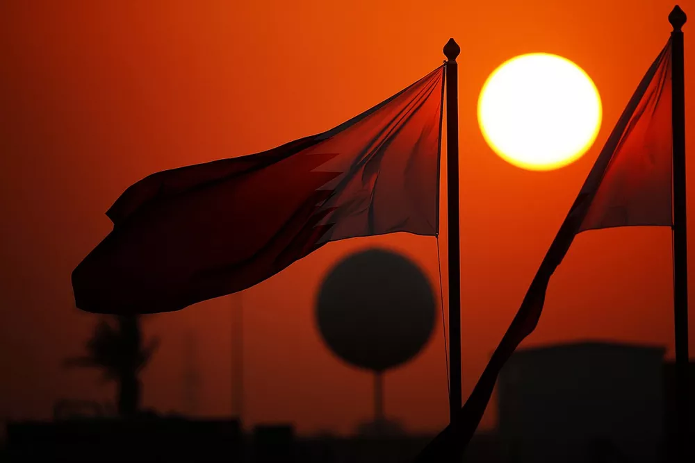 Flag of Qatar at sunset