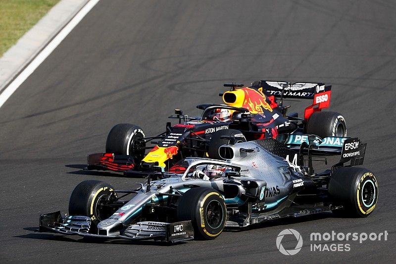 Lewis Hamilton, Mercedes AMG F1 W10 overtakes Max Verstappen, Red Bull Racing RB15 for the lead