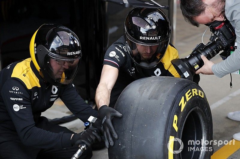 Renault F1 Team mechanics with Pirelli tyres and cameraman