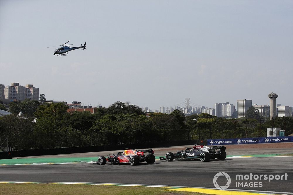 Max Verstappen, Red Bull Racing RB16B, battles with Lewis Hamilton, Mercedes W12