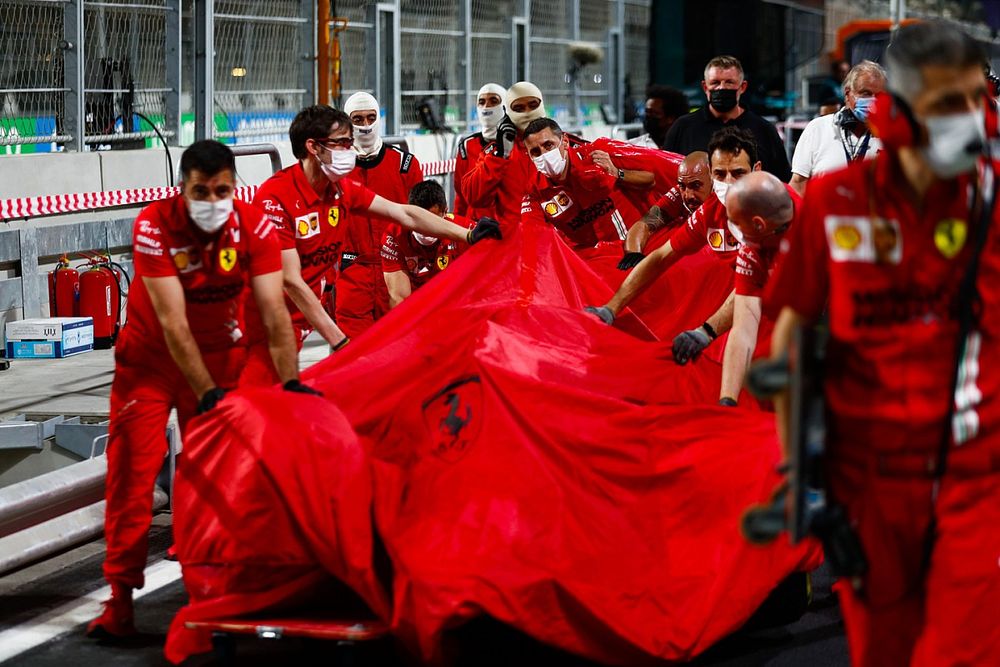 Ferrari mechanics with the damaged car of Charles Leclerc, Ferrari SF21, in the pit lane