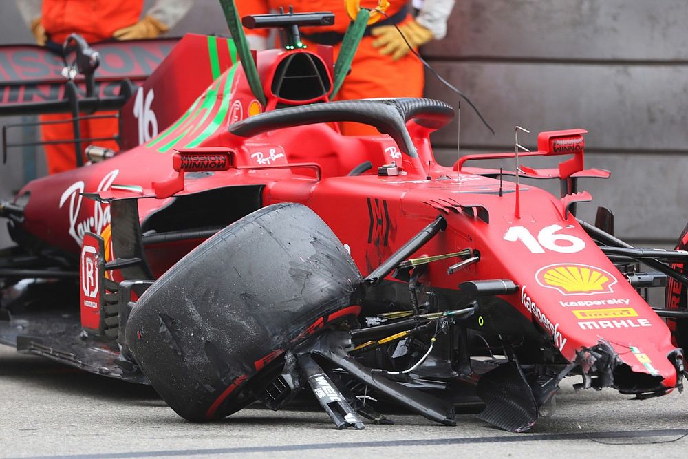 Marshals remove the car of Charles Leclerc, Ferrari SF21, from the circuit