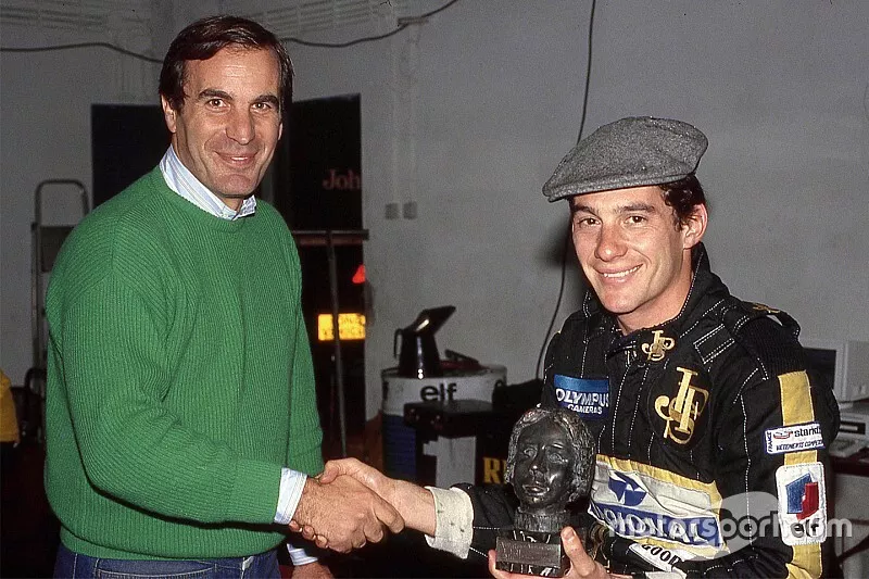 Giorgio Piola hands Ayrton Senna the Gilles Villeneuve Trophy at Imola in 1985