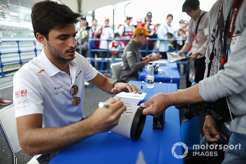 Carlos Sainz Jr., McLaren, signs autographs