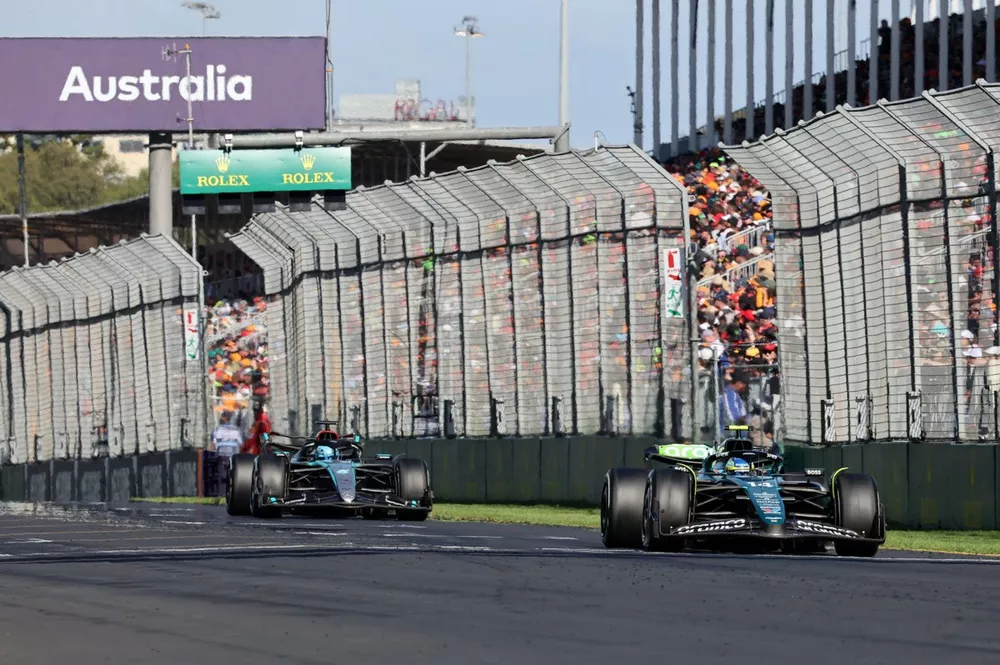 Fernando Alonso, Aston Martin AMR24, leads George Russell, Mercedes F1 W15