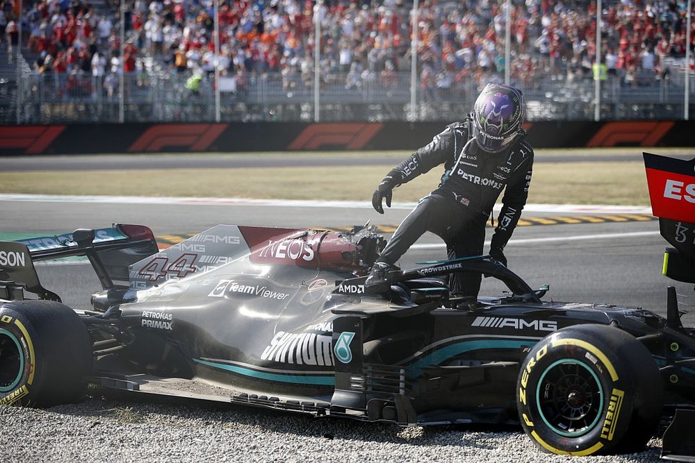 Lewis Hamilton, Mercedes, climbs out of his car after crashing out with Max Verstappen, Red Bull Racing