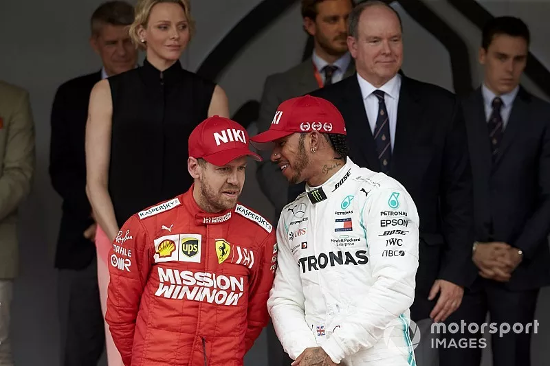 Sebastian Vettel, Ferrari, 2nd position, and Lewis Hamilton, Mercedes AMG F1, 1st position, talk on the podium
