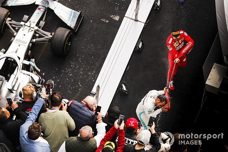 Lewis Hamilton, Mercedes AMG F1, vincitore, e Sebastian Vettel, Ferrari, terzo, spruzza lo champagne sul podio