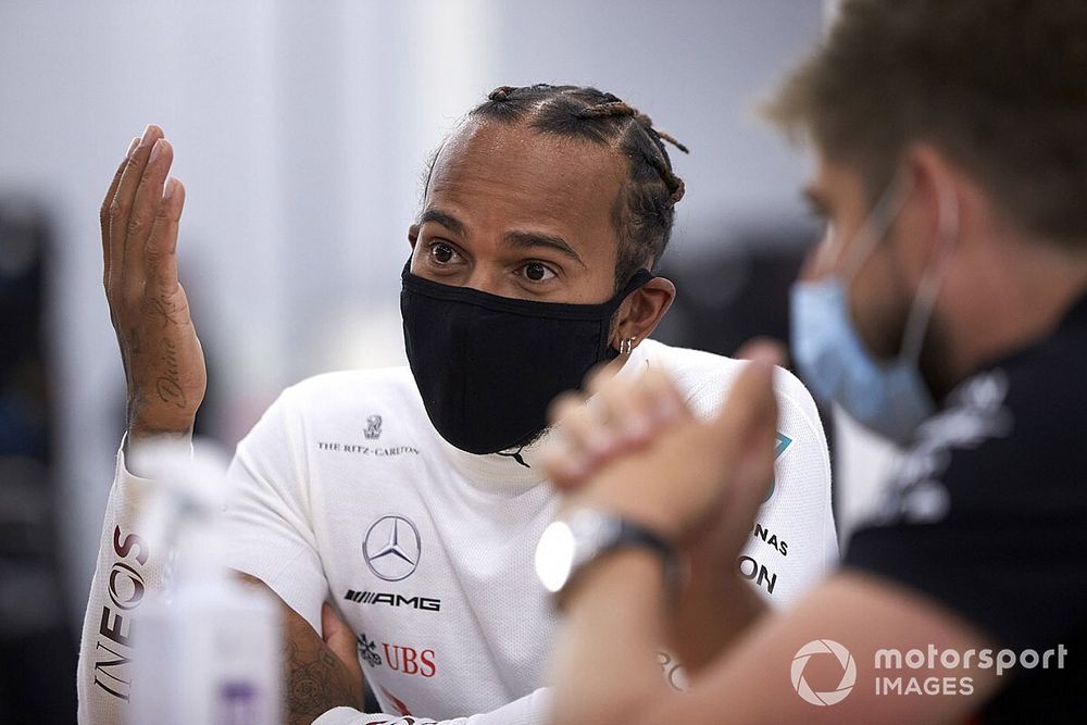 Lewis Hamilton wears a protective face mask in the garage