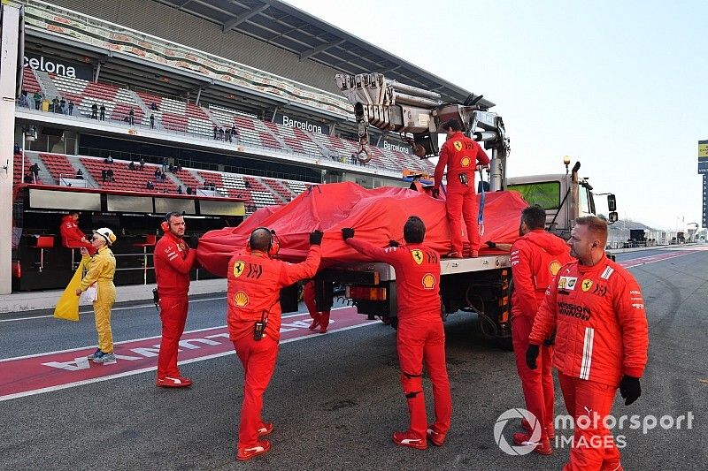 Sebastian Vettel, Ferrari, is lifted back into the garage after stopping on track 