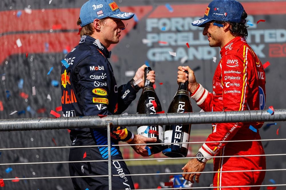 Max Verstappen, Red Bull Racing, 3rd position, Carlos Sainz, Scuderia Ferrari, 2nd position, cheer with their champagne bottles on the podium 