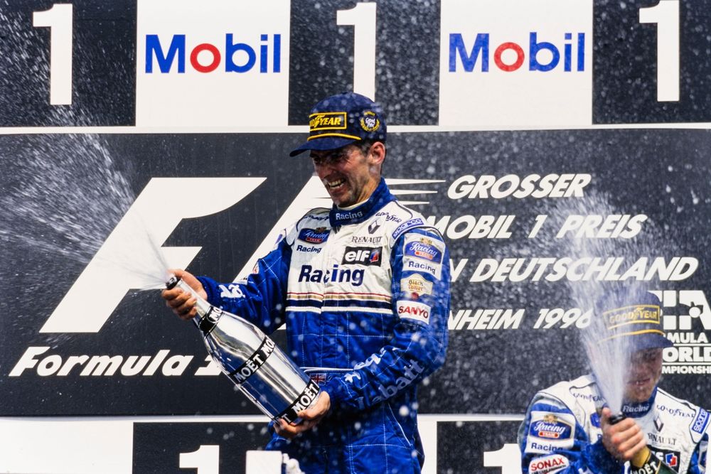 Damon Hill, Williams, 1st position, and Jacques Villeneuve, Williams, 3rd position, celebrate on the podium
